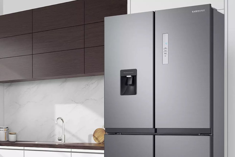 A Samsung fridge placed in a modern kitchen set-up.